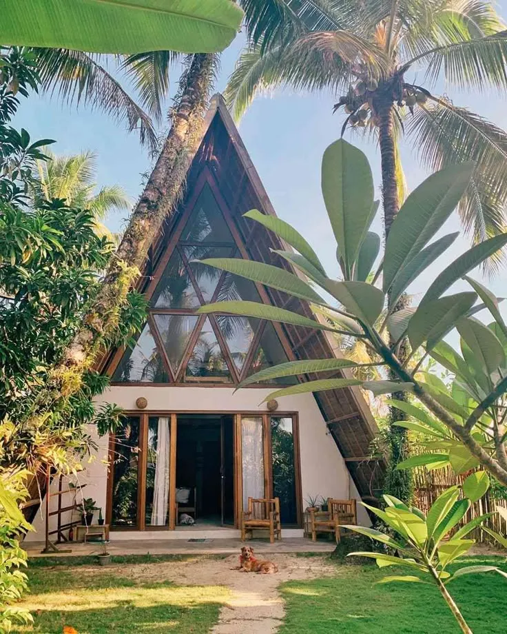 A cozy two-bedroom A-frame cabin built with natural materials and bioclimatic principles for sustainable living and eco-tourism.